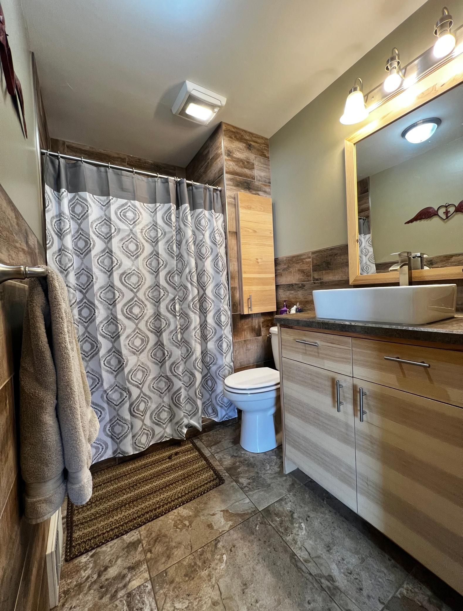Main floor 3/4 Bathroom with Barn Door & Beautiful Tile