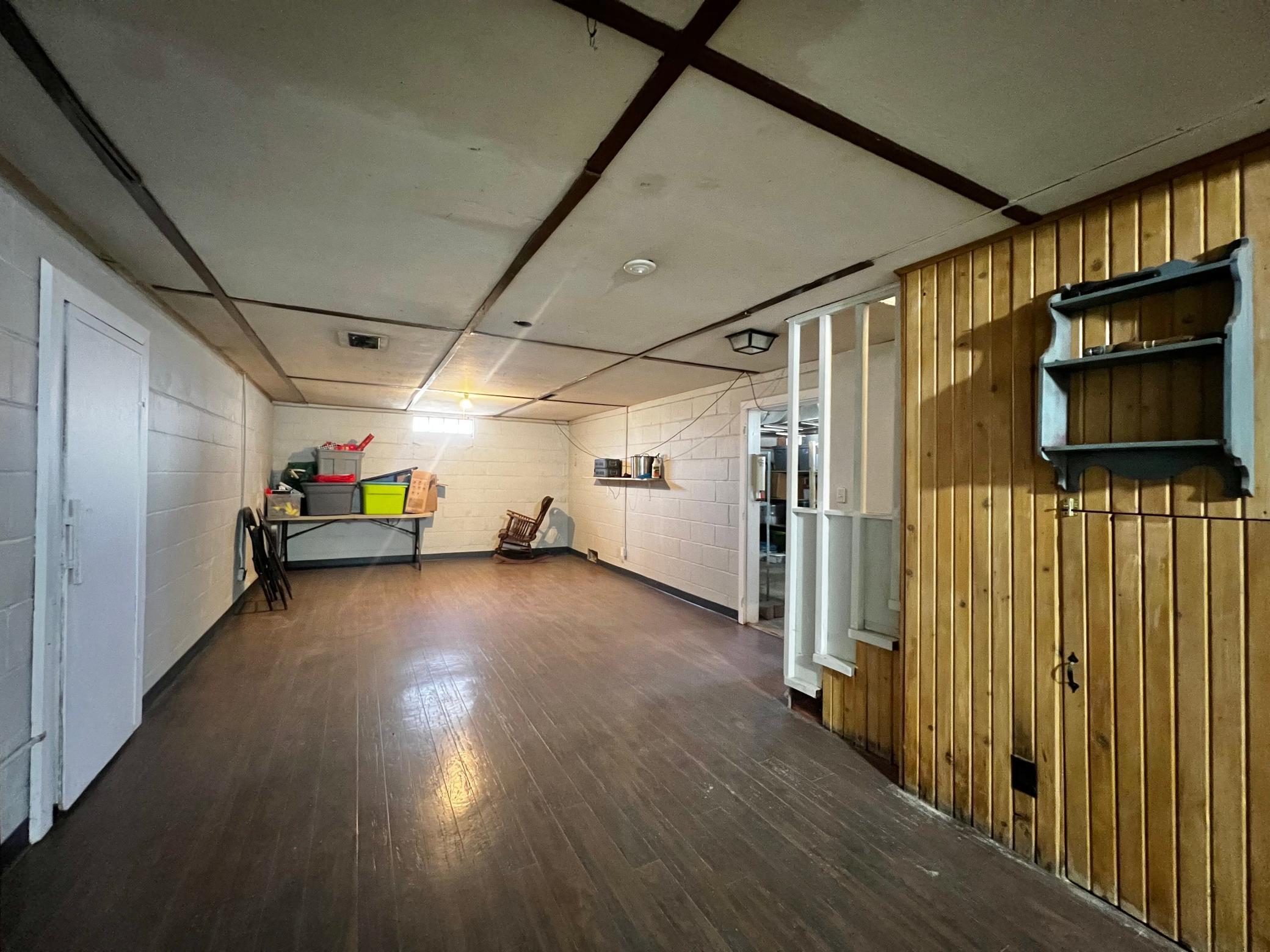 Basement Family Room, Under the stairs storage space and Basement includes a cold storage room for canned goods or other items.