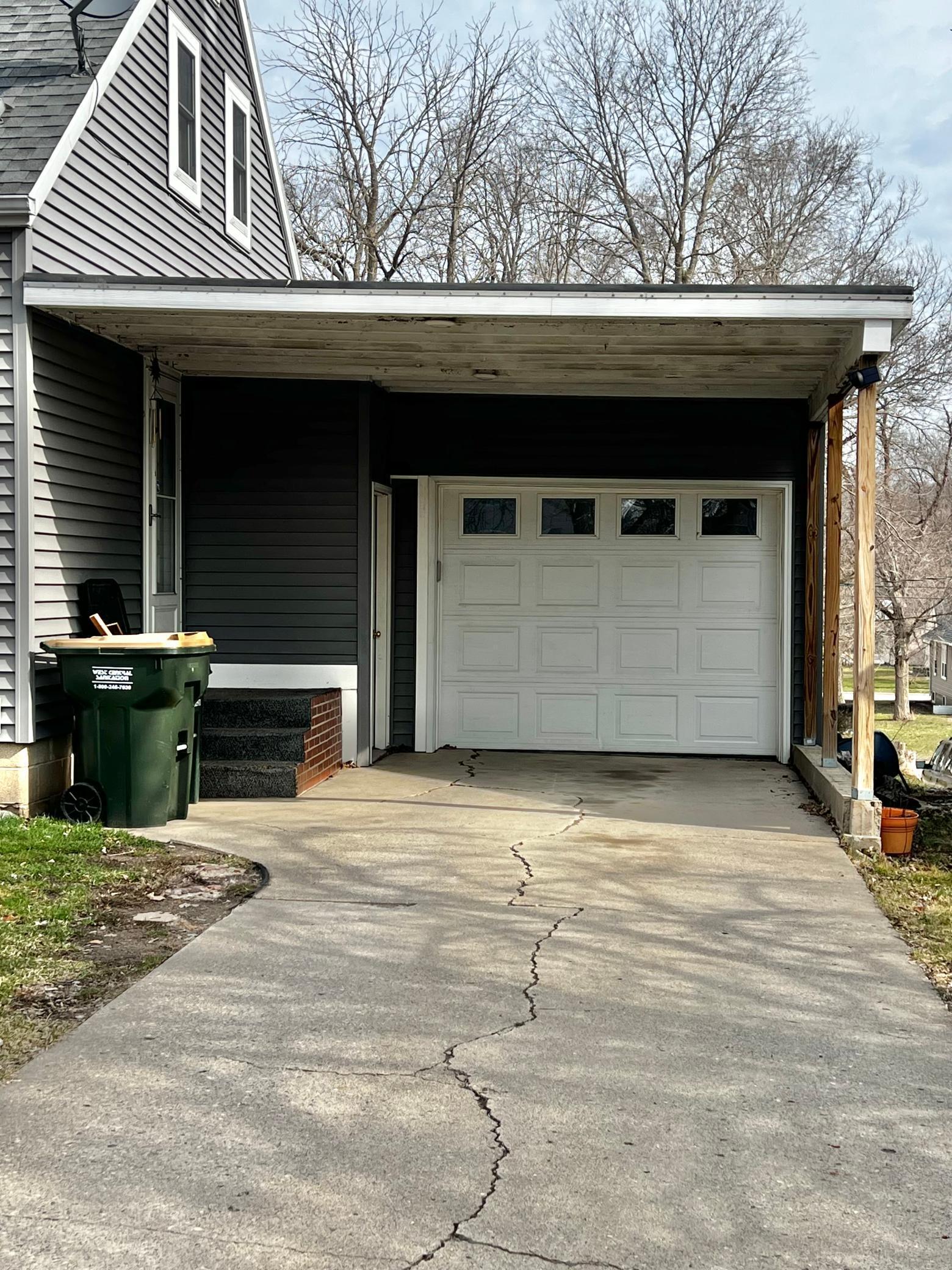 Detail of the Carport, Garage, Door to the Basement and Door to the Kitchen.