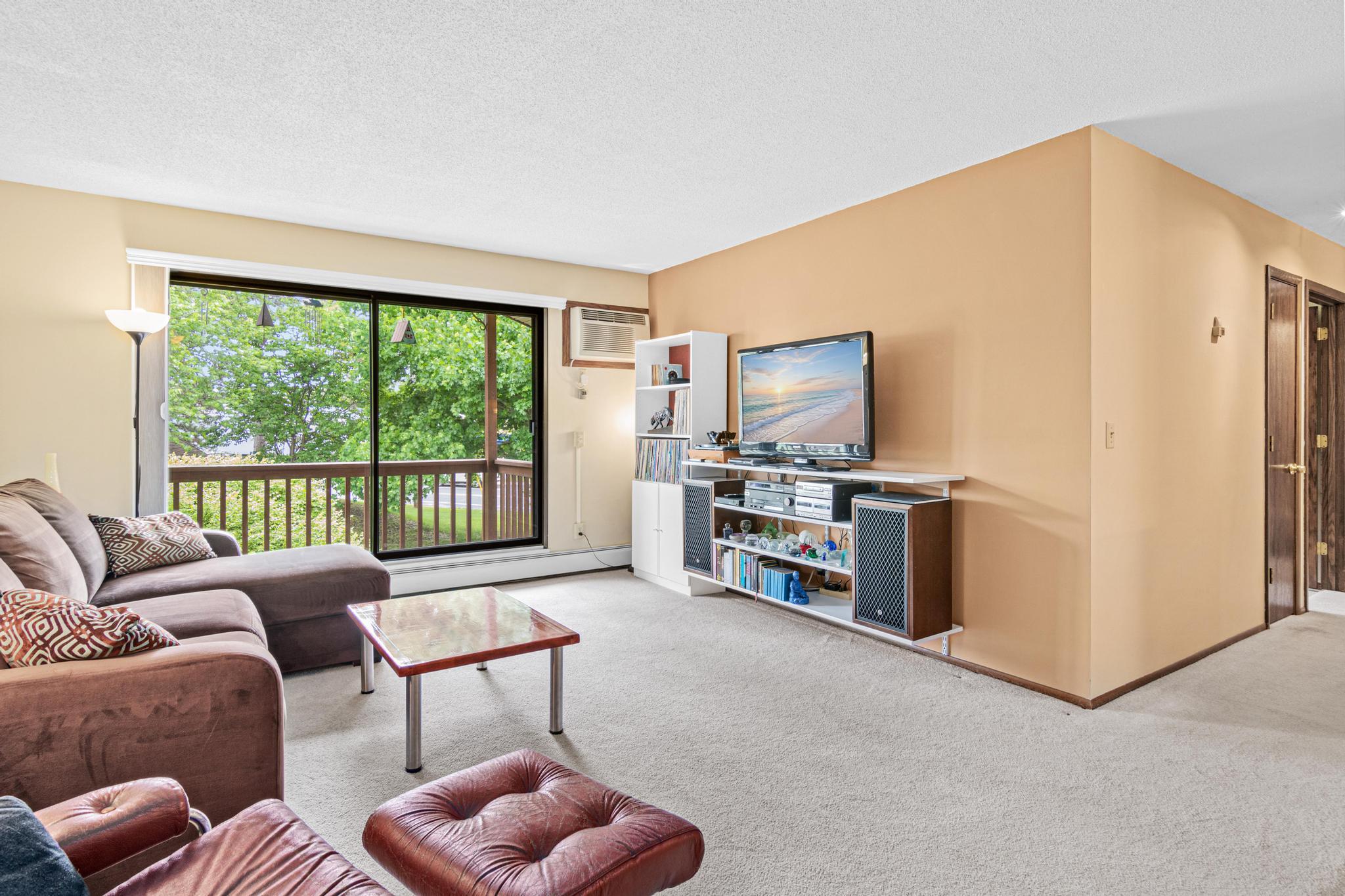 Huge living room with so much natural light and large balcony facing green space!