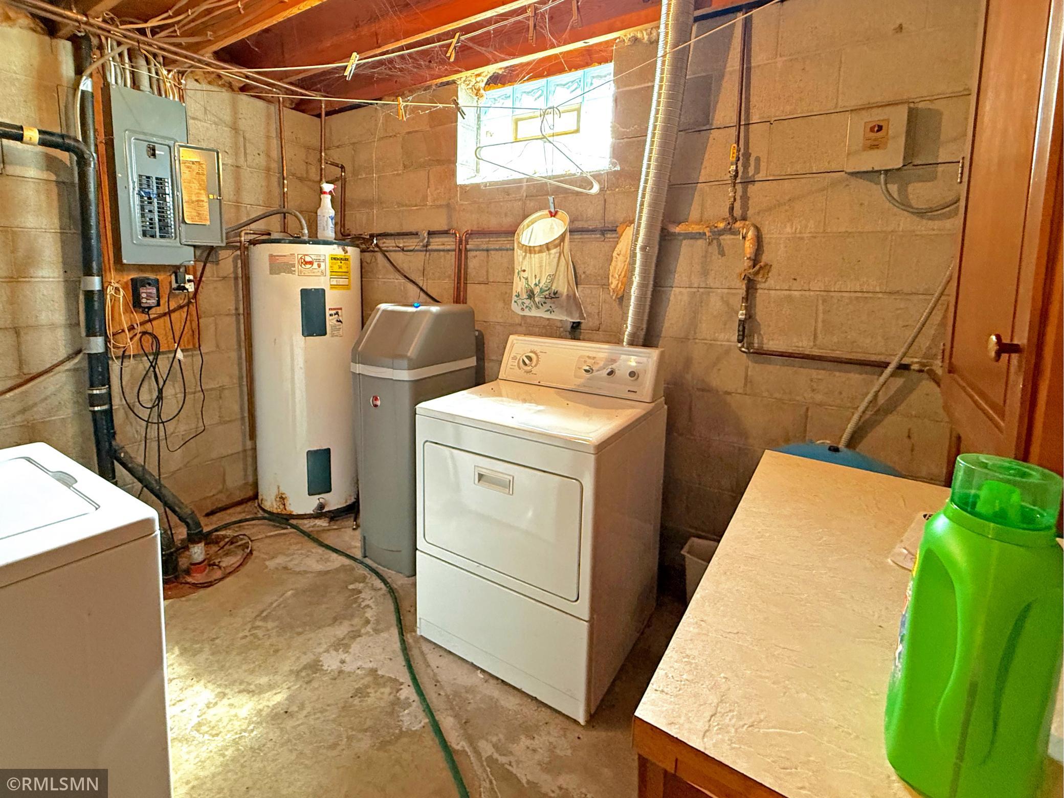 The lower level laundry and utility room offers practical functionality with plenty of space for everyday tasks and storage with washer and dryer hook-ups.
