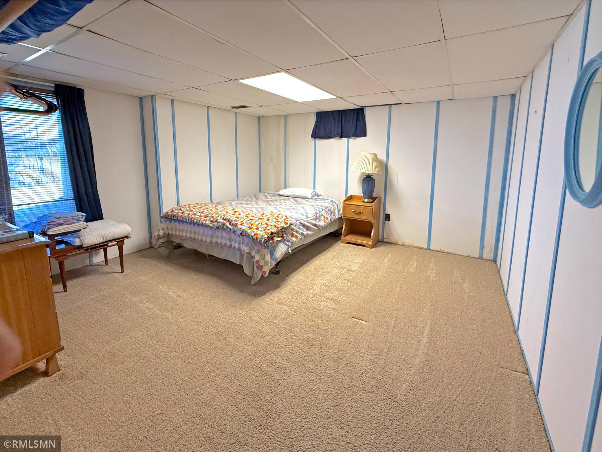 The lower level bedroom is a spacious and flexible retreat, ideal for guests or extended stays, with a generous size for additional furniture.