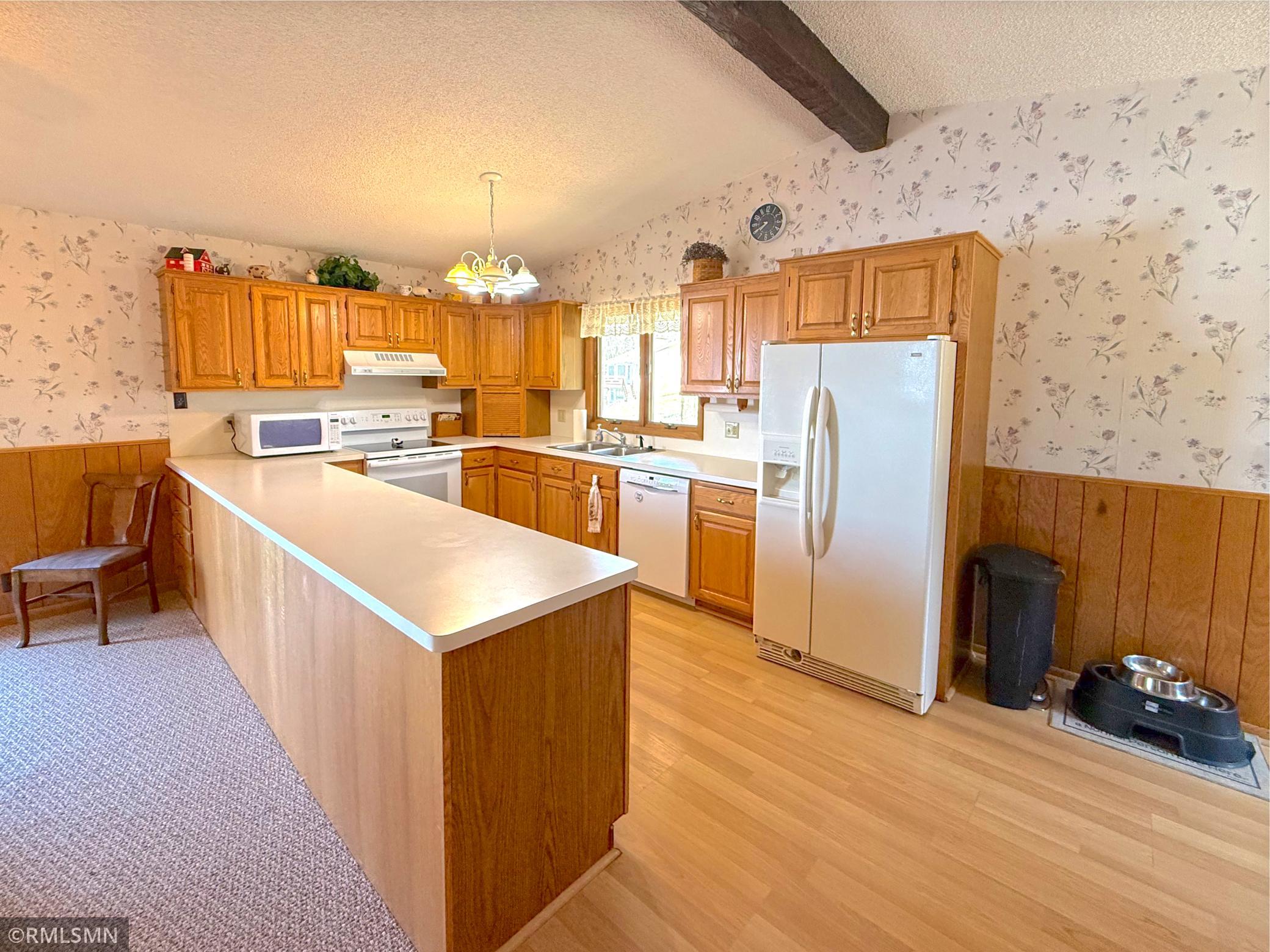 The spacious kitchen features abundant cabinetry and generous counter space, providing both functionality and room to gather.