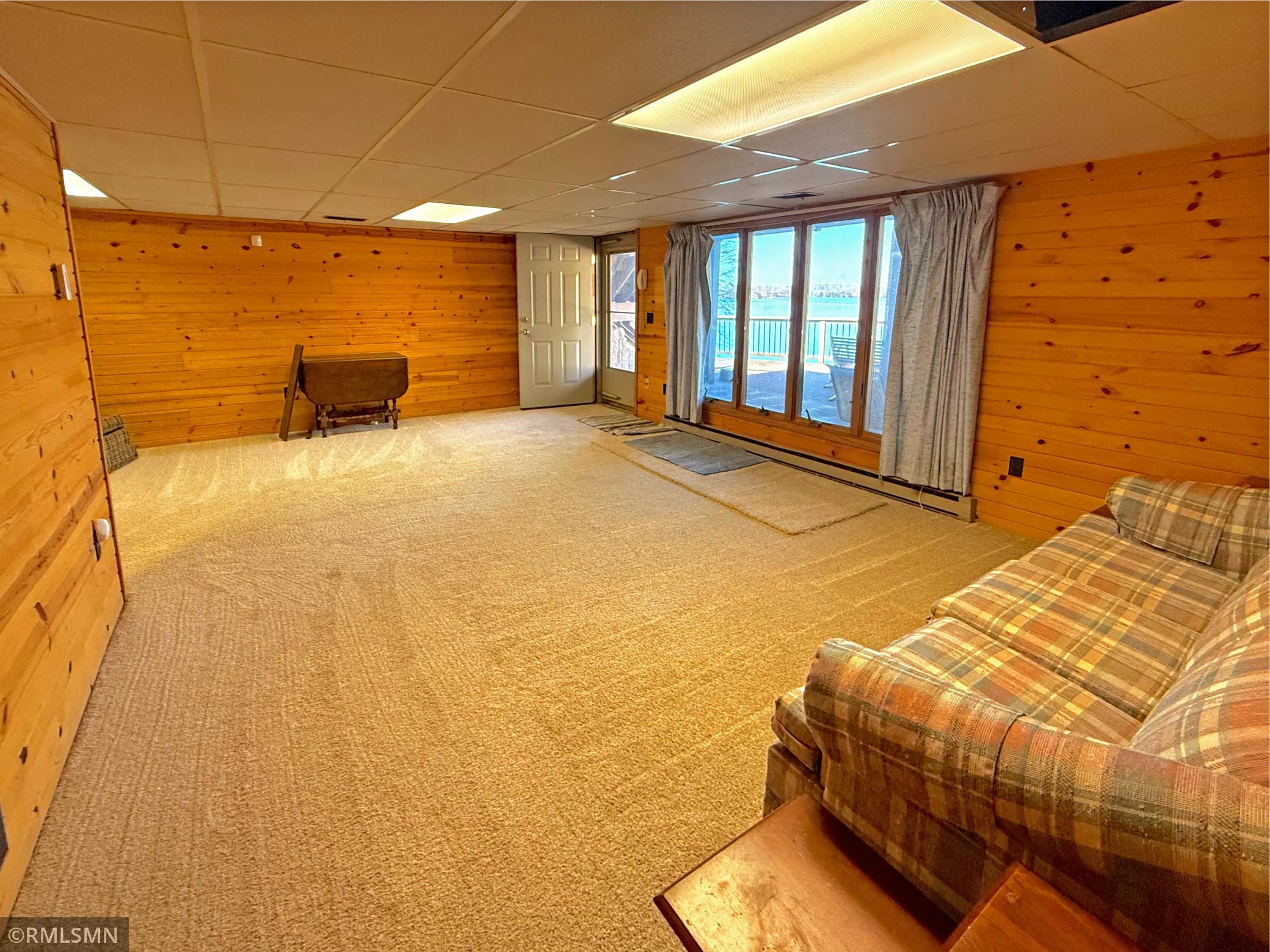 The walk-out lower level family room offers an inviting setting, while the walkout design provides direct access to an additional lakeside deck.