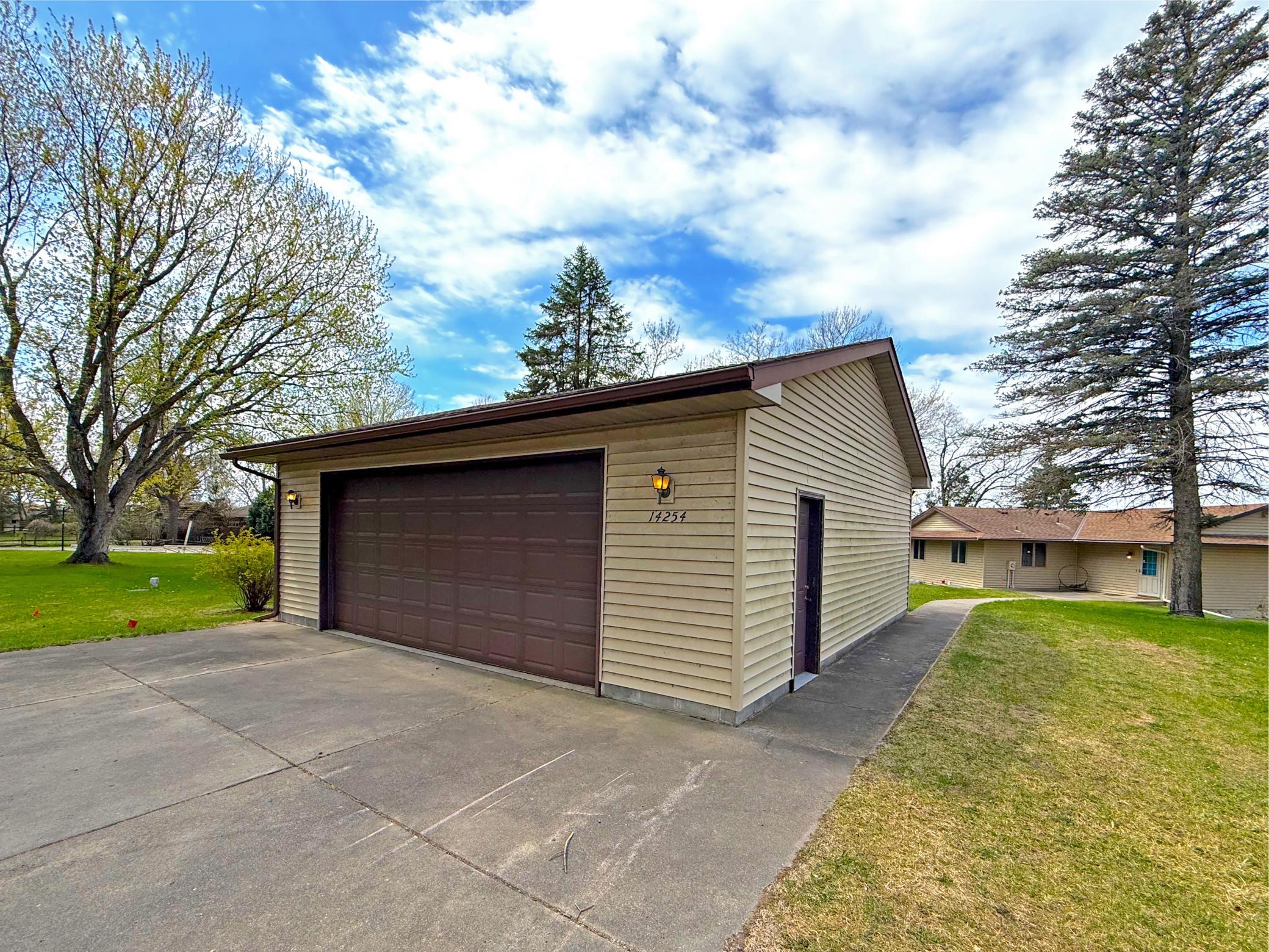 A standout feature is the spacious detached garage, perfect for vehicles and storage, complemented by a wide driveway for easy access and additional parking.