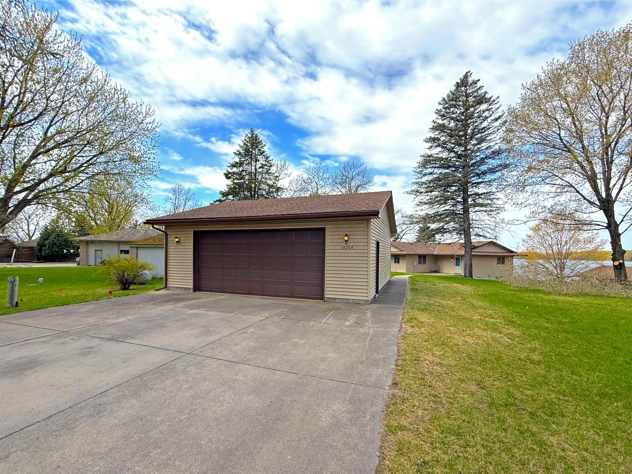 Set on a beautifully treed lot with glimpses of the lake just beyond, this inviting property offers a peaceful setting with room to relax and unwind.