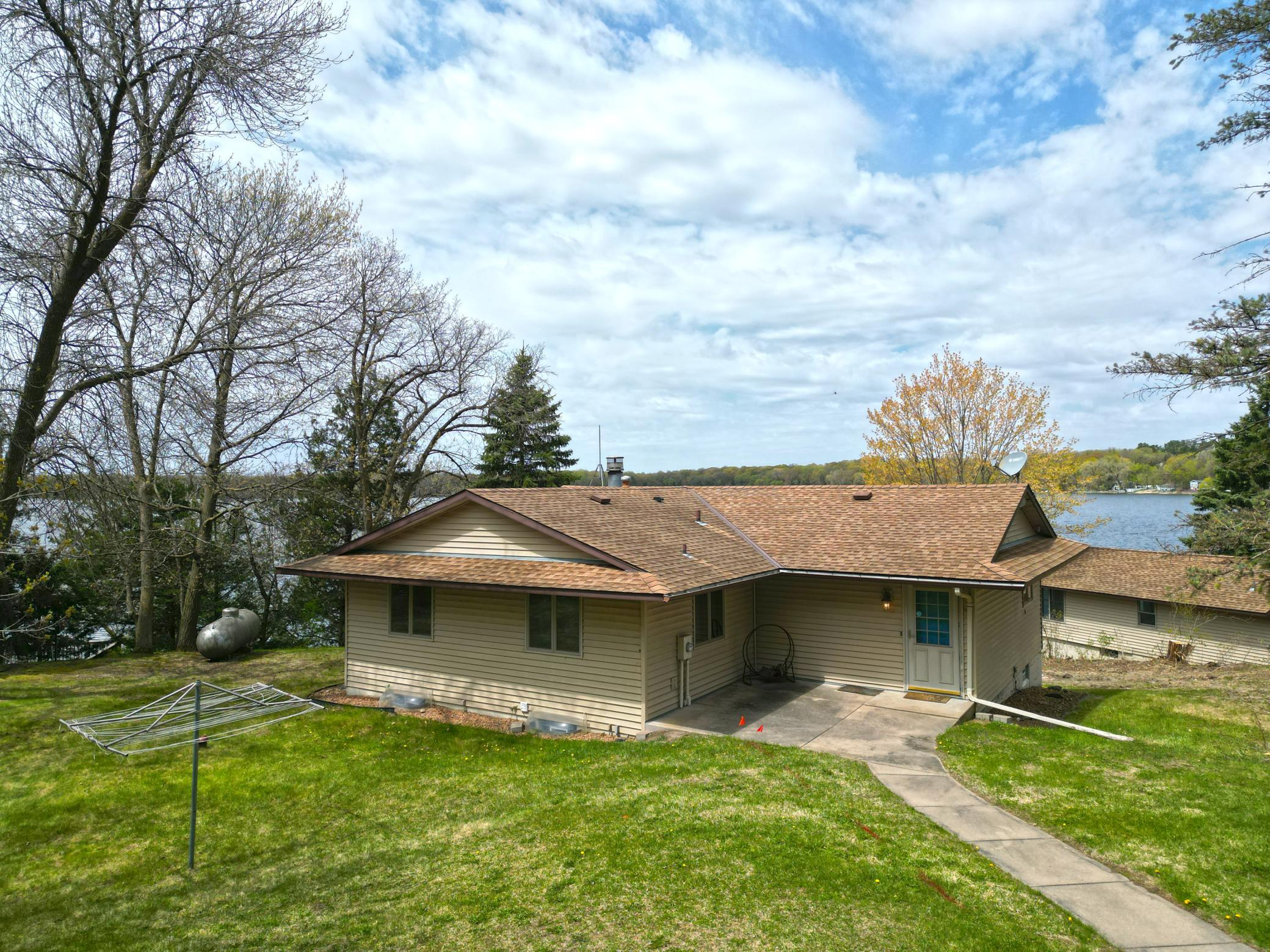 The yard offers plenty of open space for outdoor activities, entertaining, or simply enjoying the quiet lakeside atmosphere.