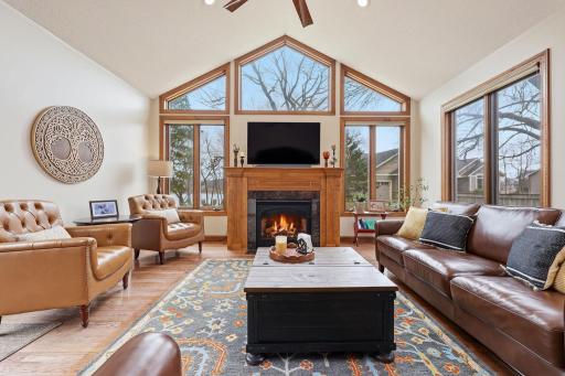 panoramic windows overlooking the lake with cozy gas fireplace