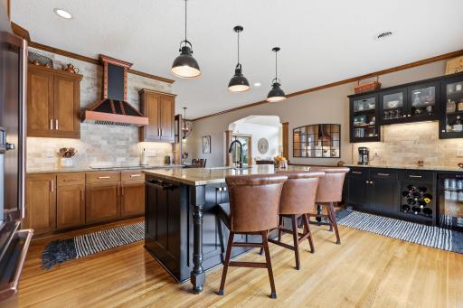 GORGEOUS CHEF KITCHEN WITH HUGE GRANITE ISLAND AND WET BAR.