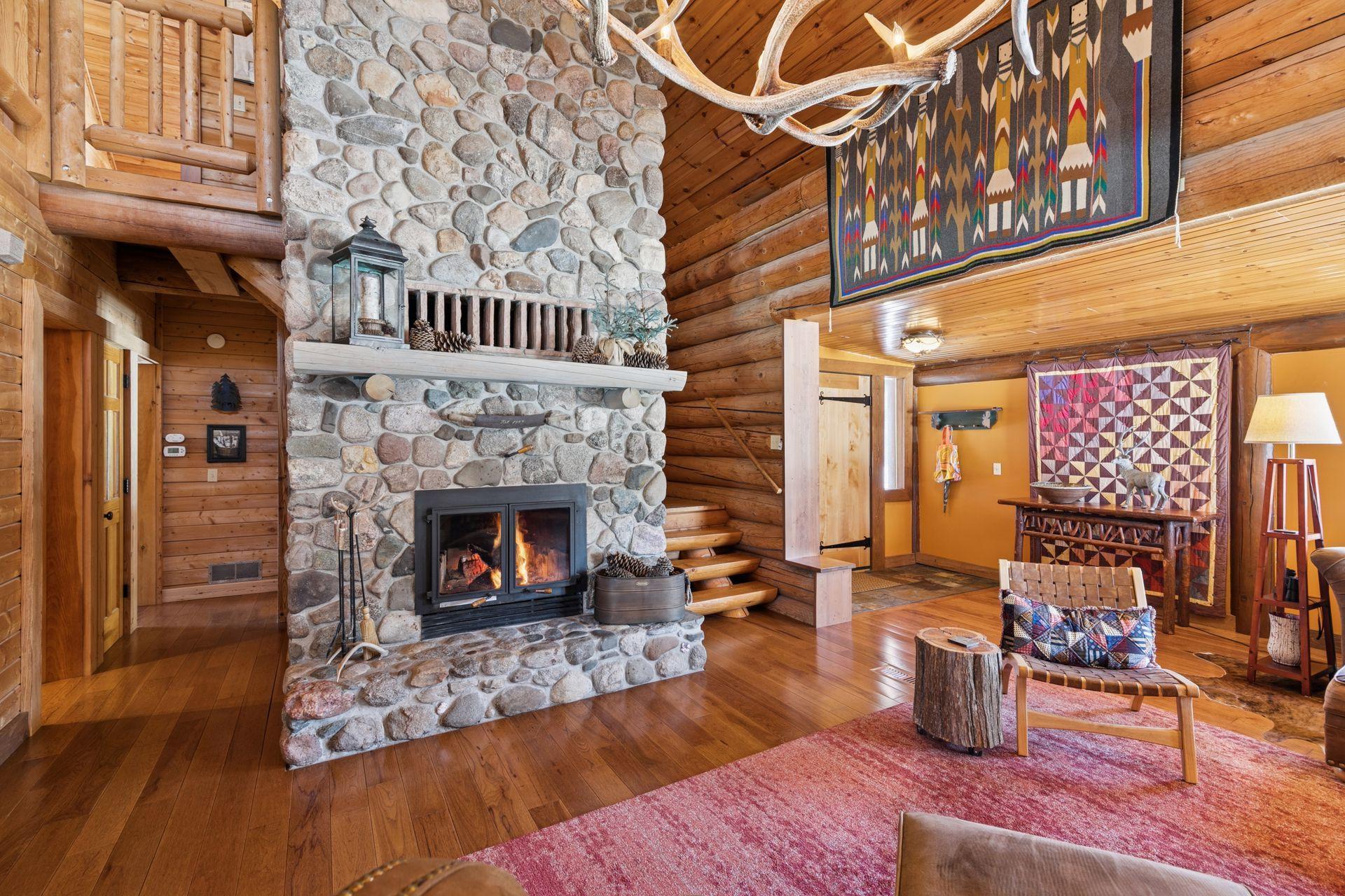 The fireplace is beautifully crafted from fieldstone collected right from the property, adding a truly custom touch and a rustic connection to the land itself.