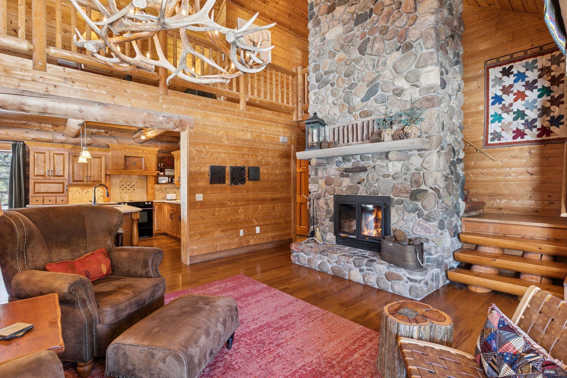 The living room is anchored by rich hickory flooring throughout, adding warmth, character, and natural beauty to the space.