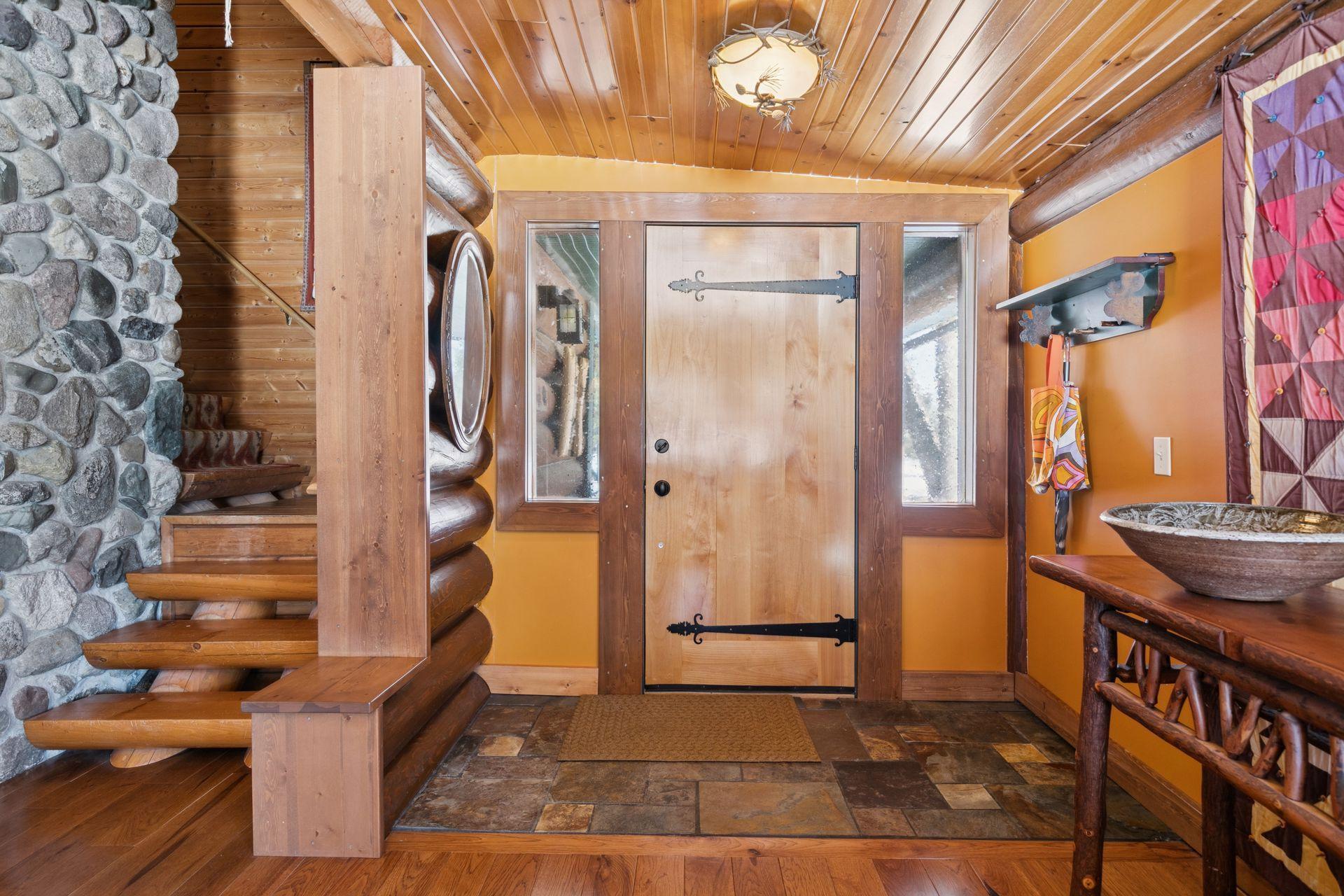 The custom solid Alder front door creates a warm and inviting first impression as you step into the welcoming foyer.