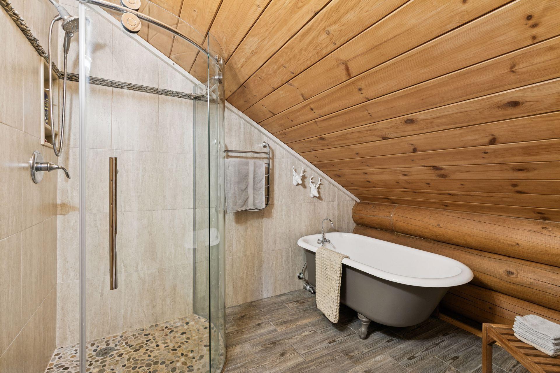 The primary bathroom features a beautifully tiled shower and a relaxing soaker tub, creating a spa-like retreat within the home.