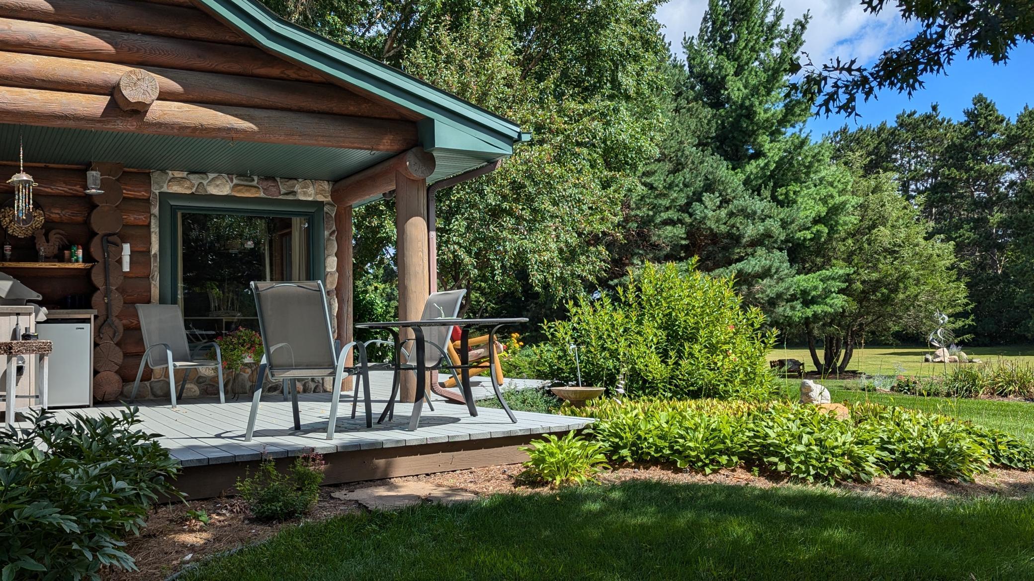 Outdoor kitchen and patio offers Weber gas grill as well as a built in refridgerator.