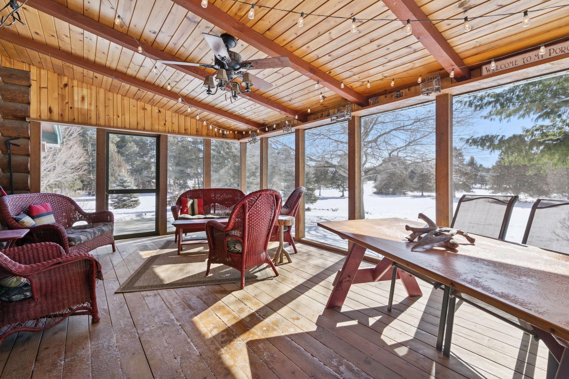The screened-in porch overlooks a spacious green area where deer and other wildlife frequently graze and roam, offering a serene and picturesque view right from your home.