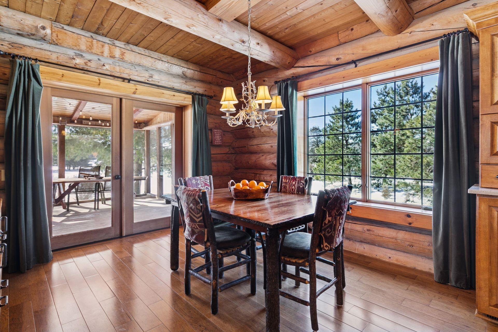 The dining room is bathed in natural light and provides direct access to the screened-in porch, creating a bright and inviting space for meals and gatherings.