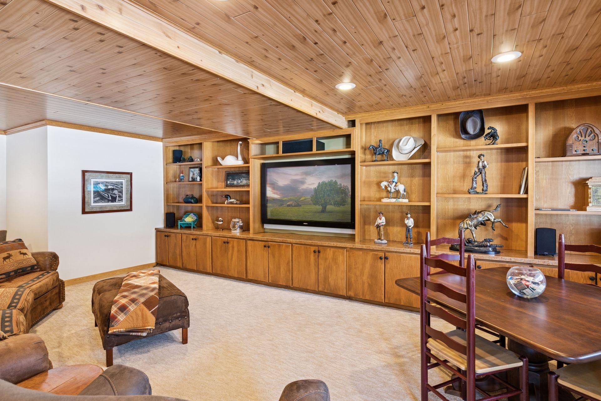 The family room is enhanced with custom built-in shelving and storage, offering both functionality and a polished, tailored look.