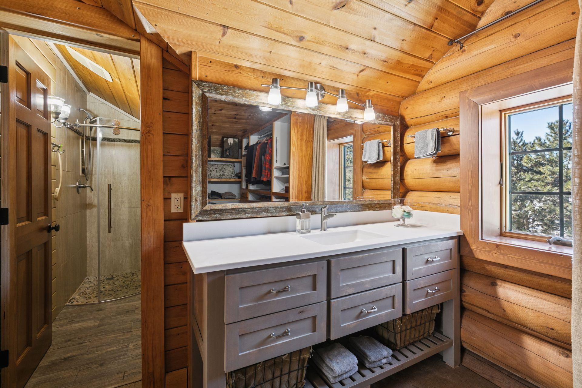 The primary bedroom includes a unique vanity located within the walk-in closet, offering a private and convenient space for getting ready.