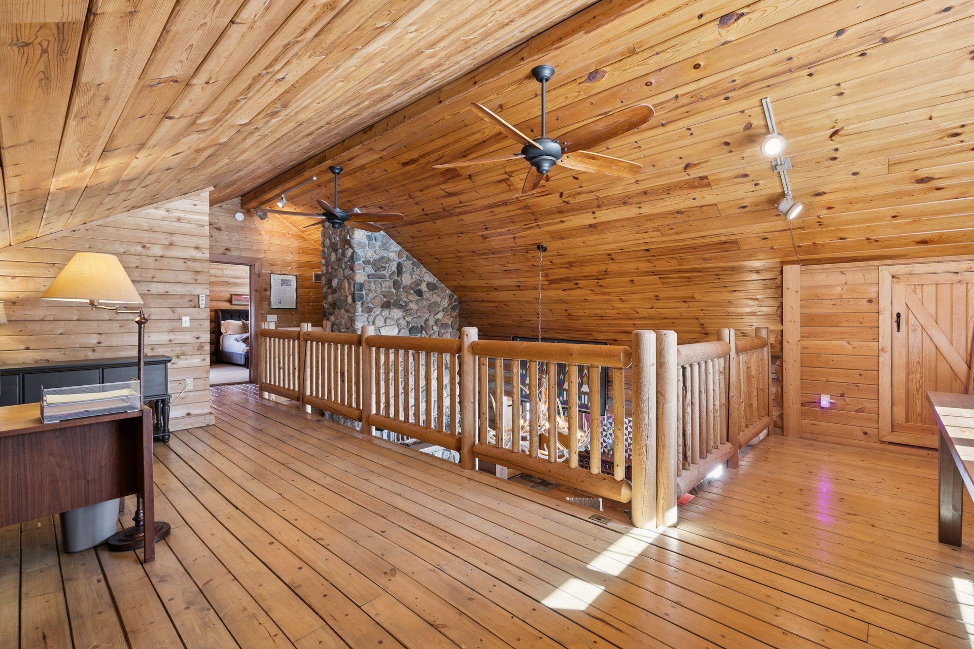 The upper-level loft overlooks the living room and provides a versatile space perfect for an office, entertainment area, or workout zone.