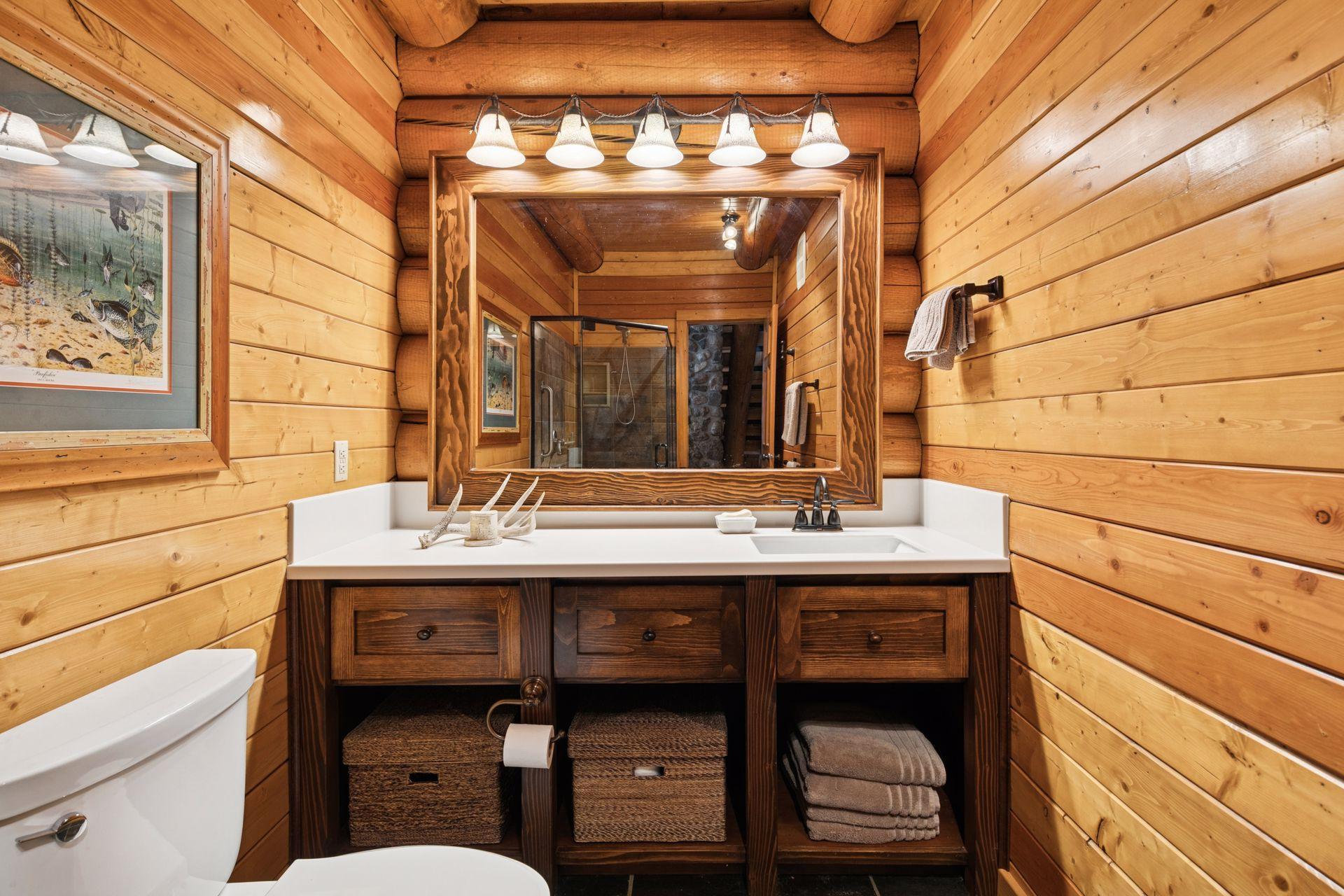 Main level bath with custome vanity and natural slate flooring