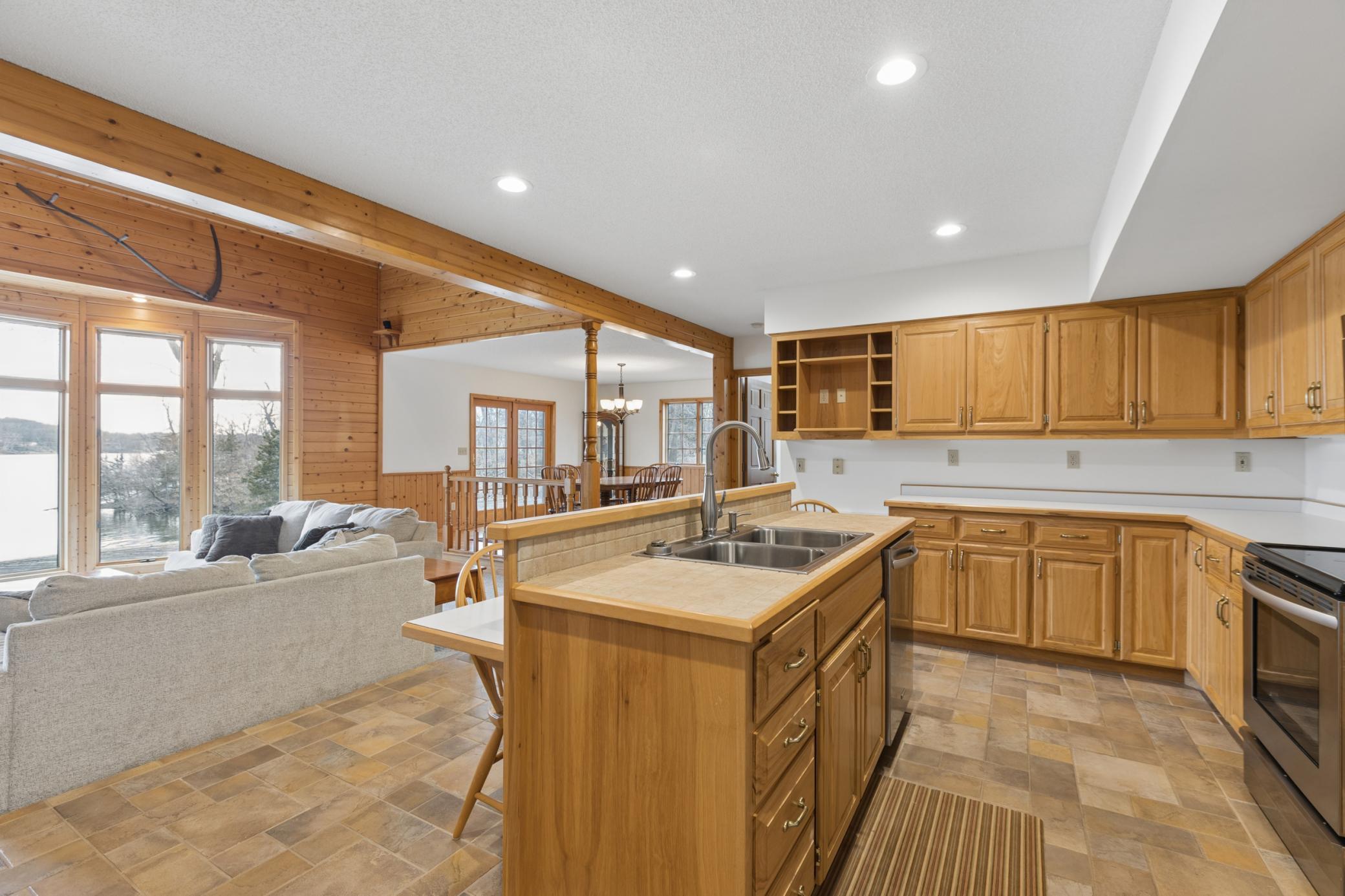 The open design of this custom-built home allows everyone to be together from the kitchen through the living room and dining room.