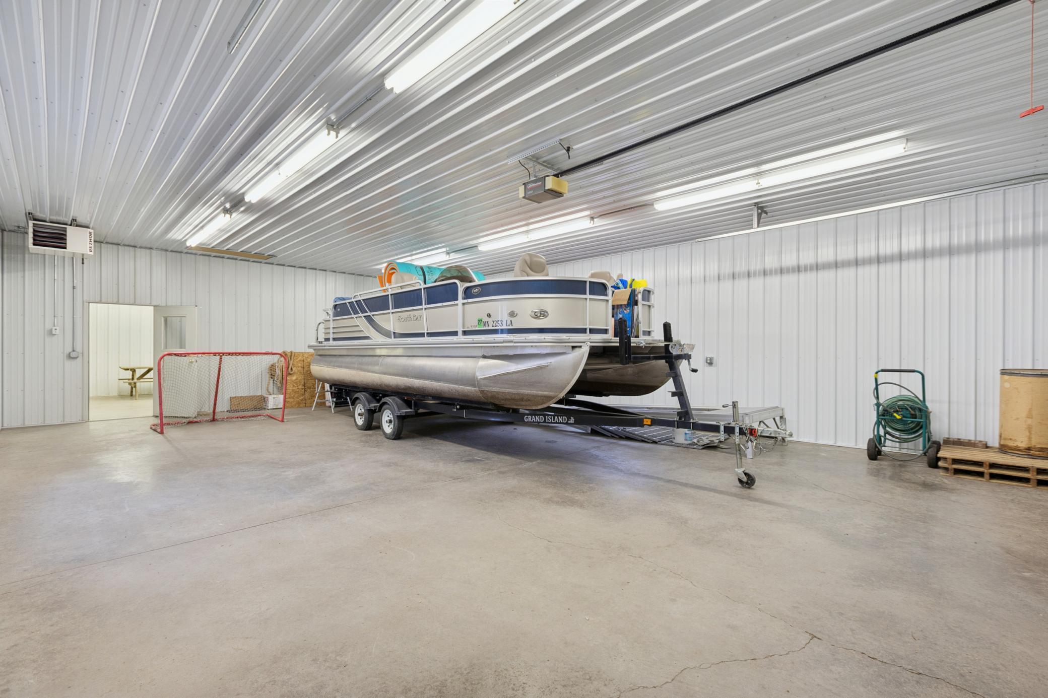 The larger portion of the 1600+ sqft finished, heated pole shed measures 40x28 with a forced air propane heater.