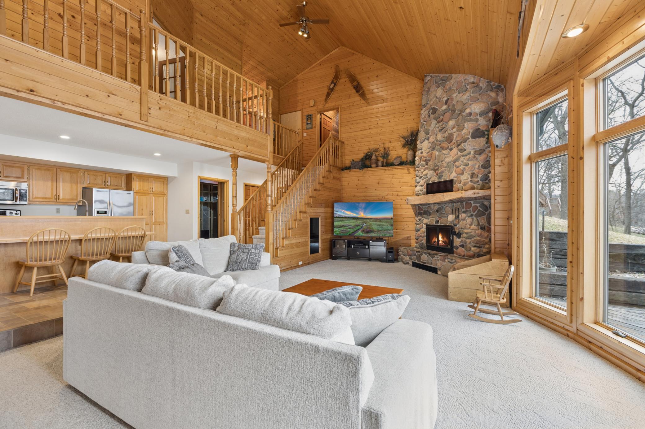 You will fall in love with the style and features of this home including the vaulted ceiling, natural woodwork and large woodburning stone fireplace.
