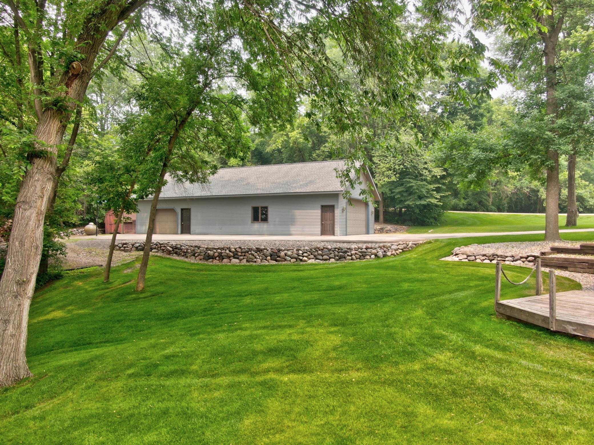 The 1.31 acre lot offers many mature trees providing a canopy of shade overhead along with a manicured lawn with in-ground sprinkler system and lake pump.