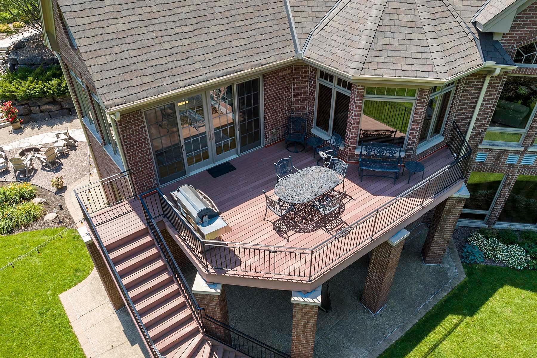 The maintenance-free deck off the sunroom offers a spacious outdoor living area perfect for relaxing or entertaining year-round.