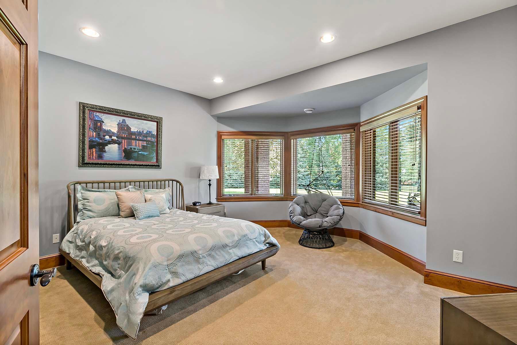 Large lower level bedroom with bay windows