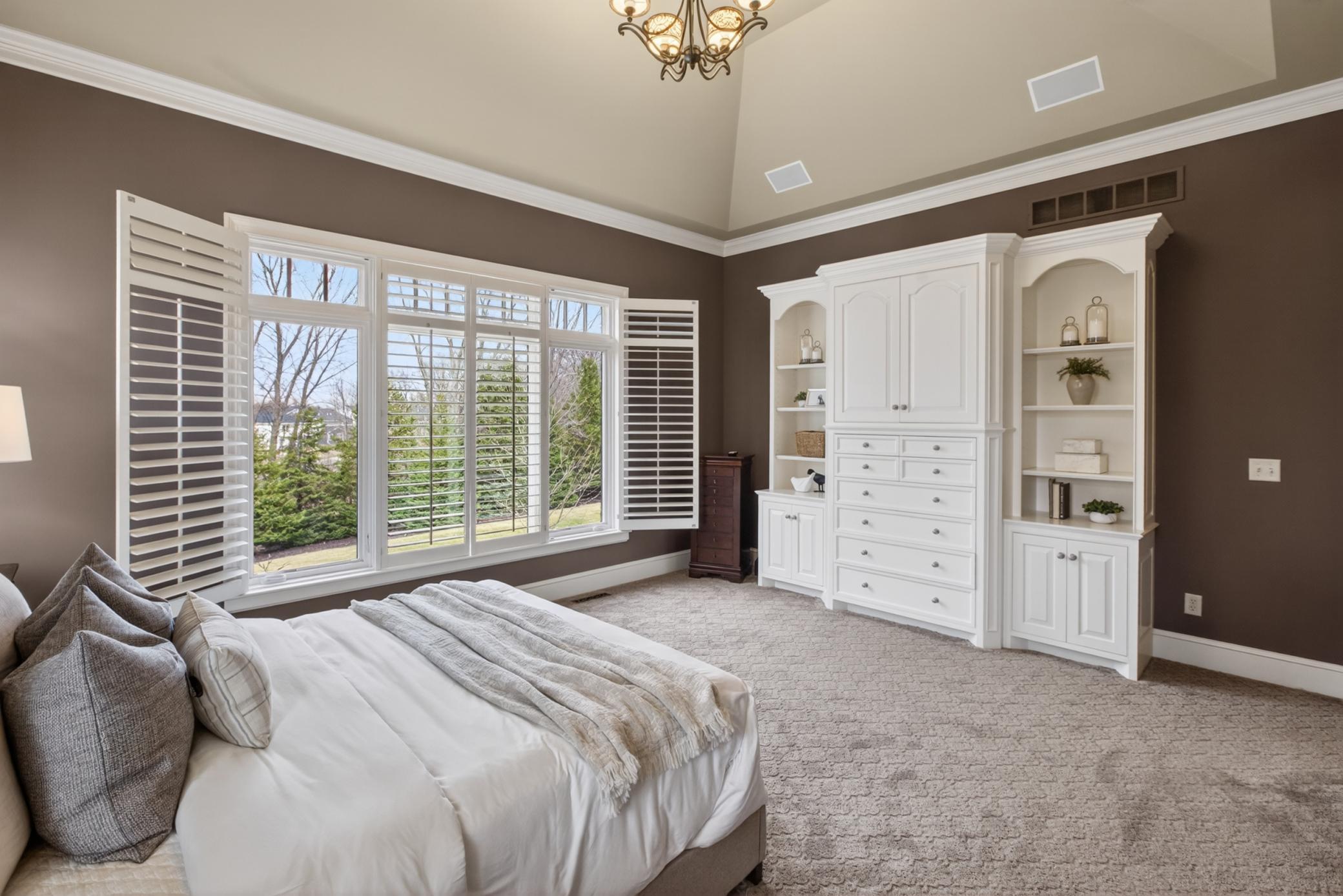 Large primary bedroom on main level with custom built-ins