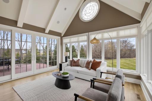 Sun filled and heated floor sunroom off the kitchen
