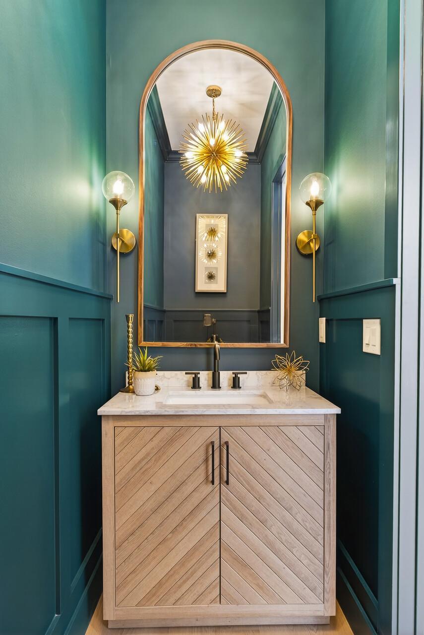 Striking powder room with elegant, moody design - sure to impress your guests