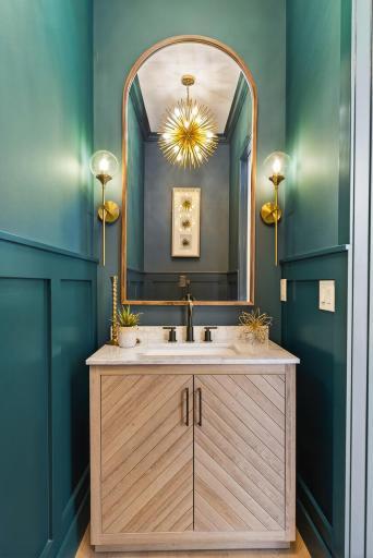 Striking powder room with elegant, moody design - sure to impress your guests