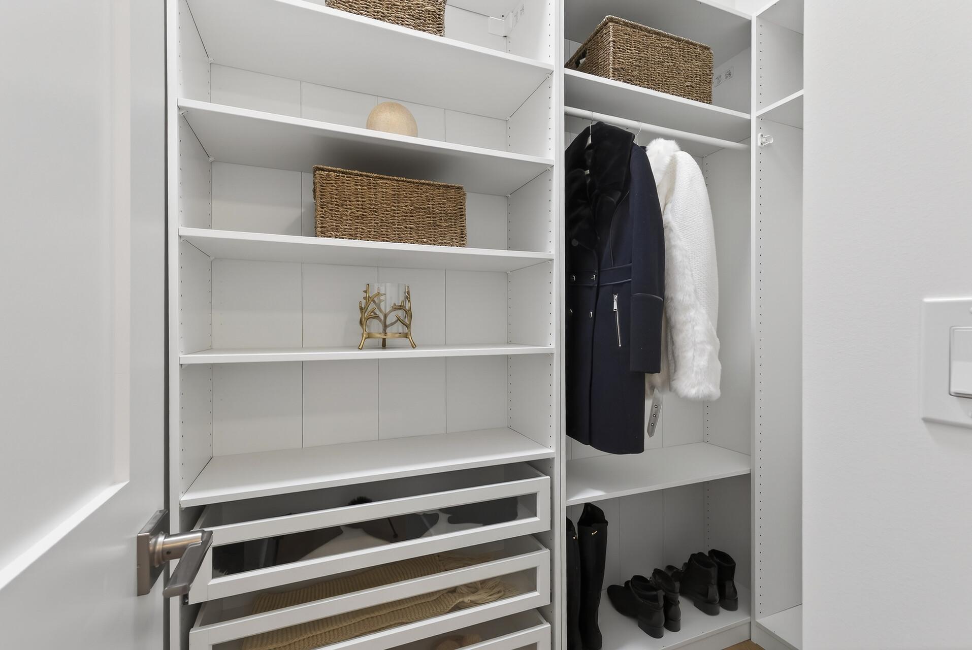 Functional mudroom with bench, hooks, cubbies, and adjacent walk-in closet for all-season storage