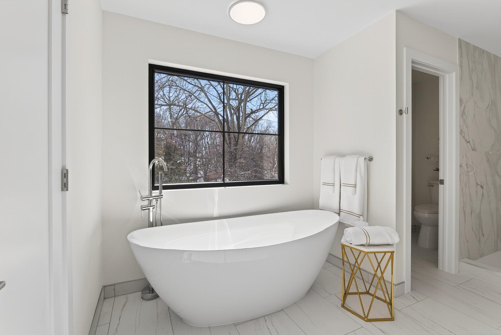 Primary bathroom featuring a large soaking tub