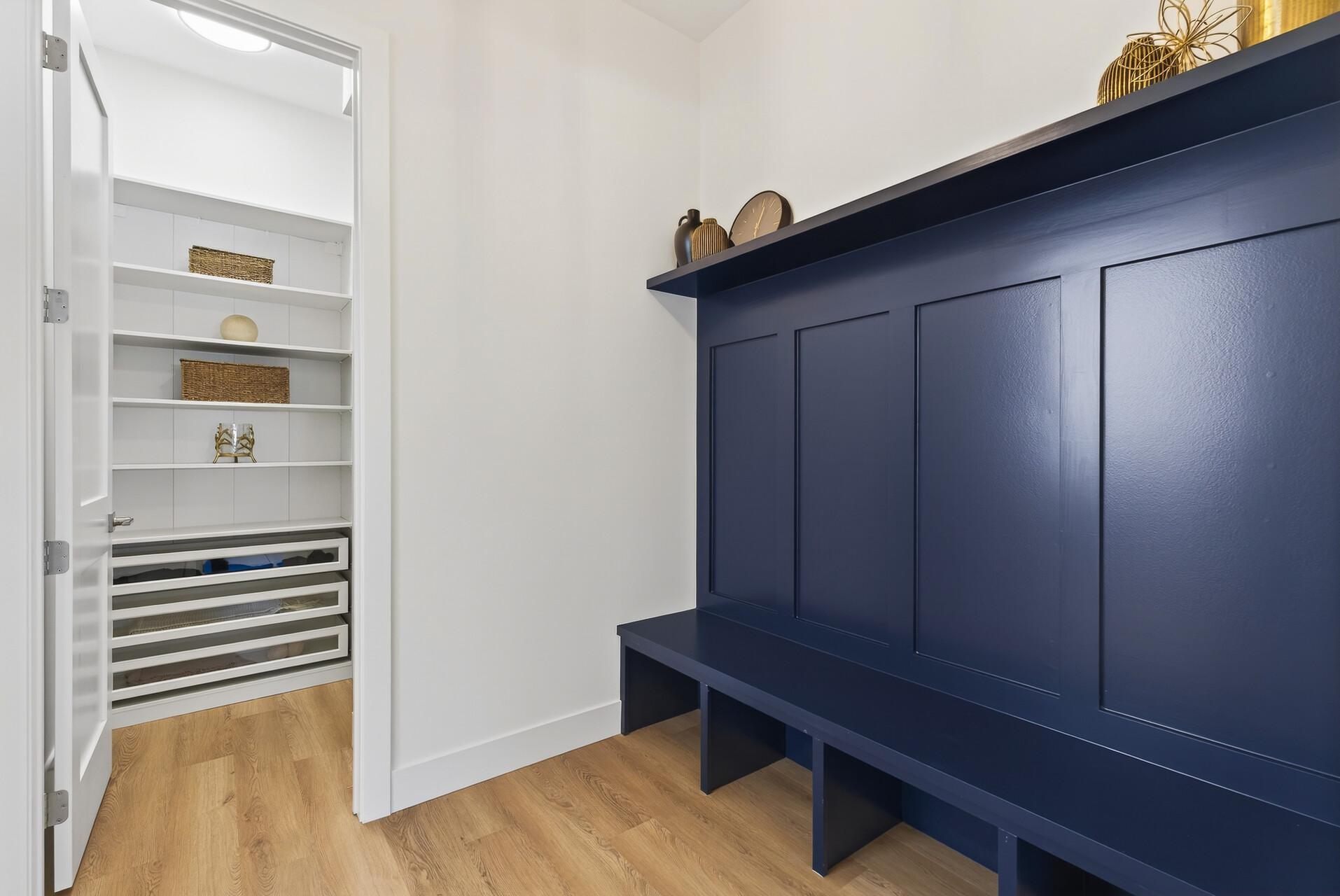 Functional mudroom with bench, hooks, cubbies, and adjacent walk-in closet for all-season storage
