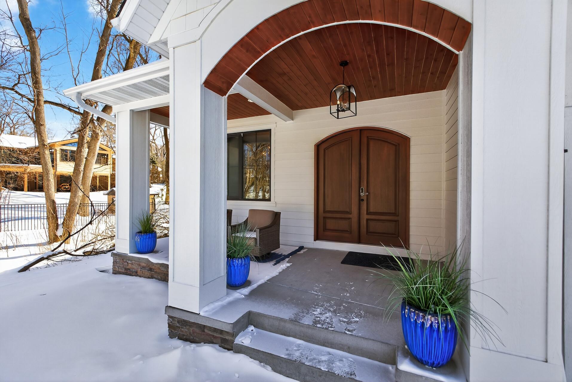 Oversized front porch with custom wood ceiling