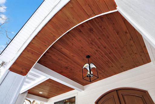 Oversized front porch with custom wood ceiling