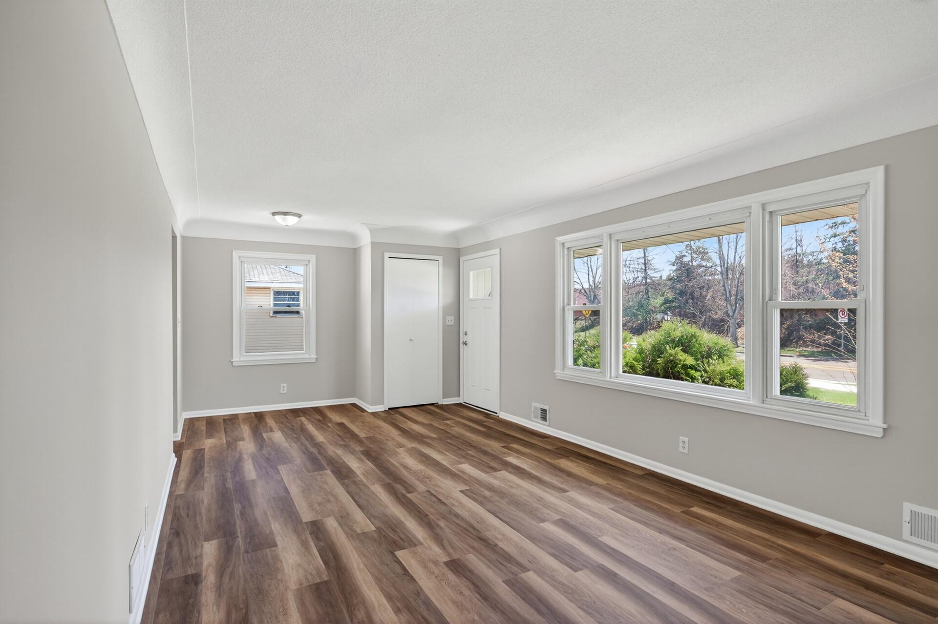 Abundant natural light streams through the large picture window for an open and bright living space.