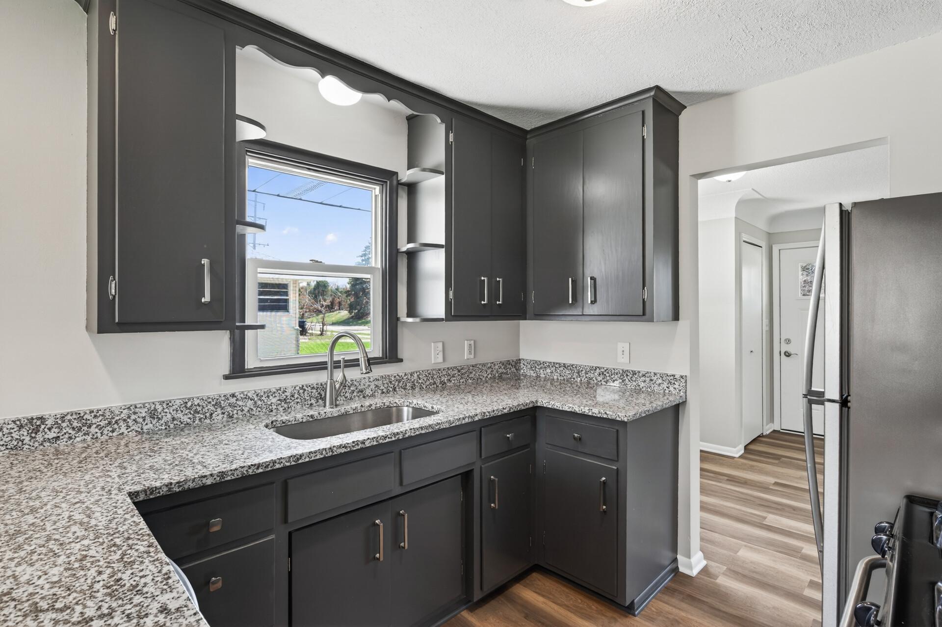 A kitchen window brings in natural light and offers peaceful views of the outdoors.