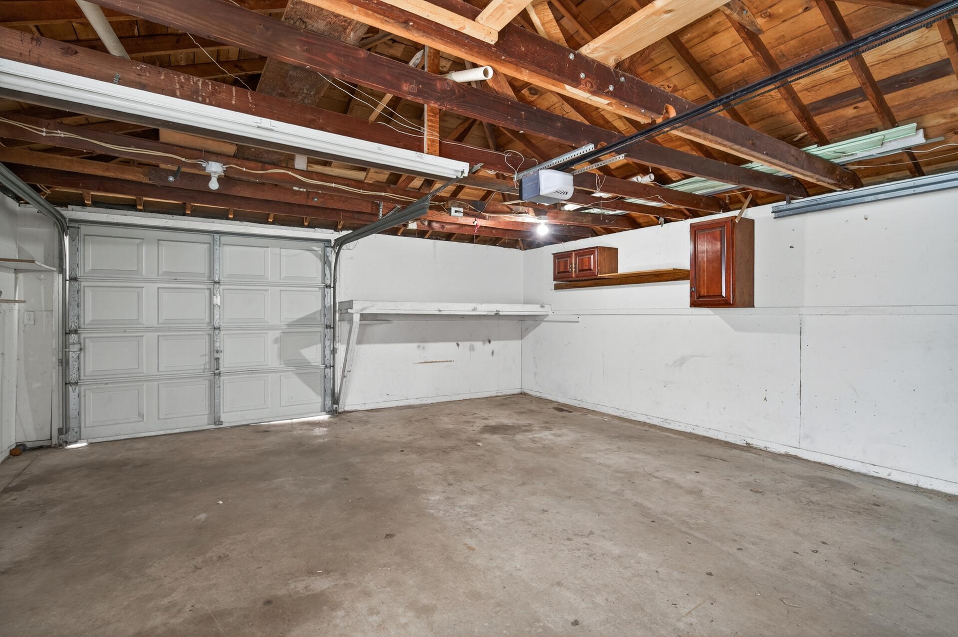 Detached two car garage with an additional rear door for easy access to the backyard, perfect for lawn equipment and outdoor tools.