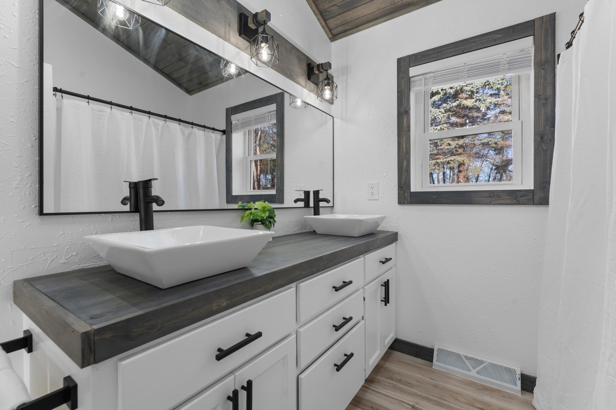 The spacious layout, dual sinks, and vanity with extra storage make busy morning routines both easy and functional.