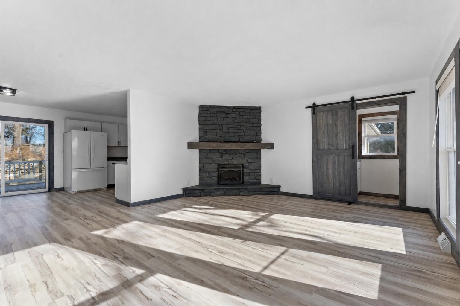 The living room is centered around a cozy fireplace adding warmth to the space. Transition out onto one of two decks for effortless indoor-outdoor entertaining.