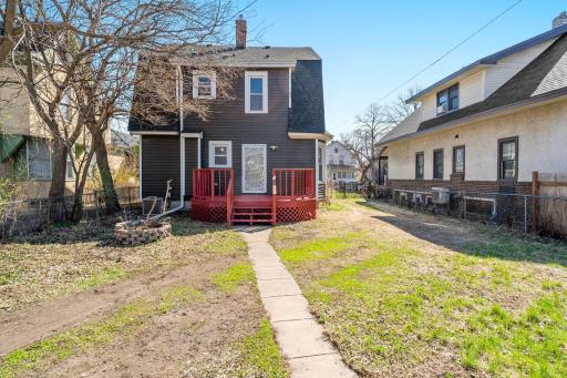 Just beyond the deck, a raised fire pit creates a space perfect for cozy nights.