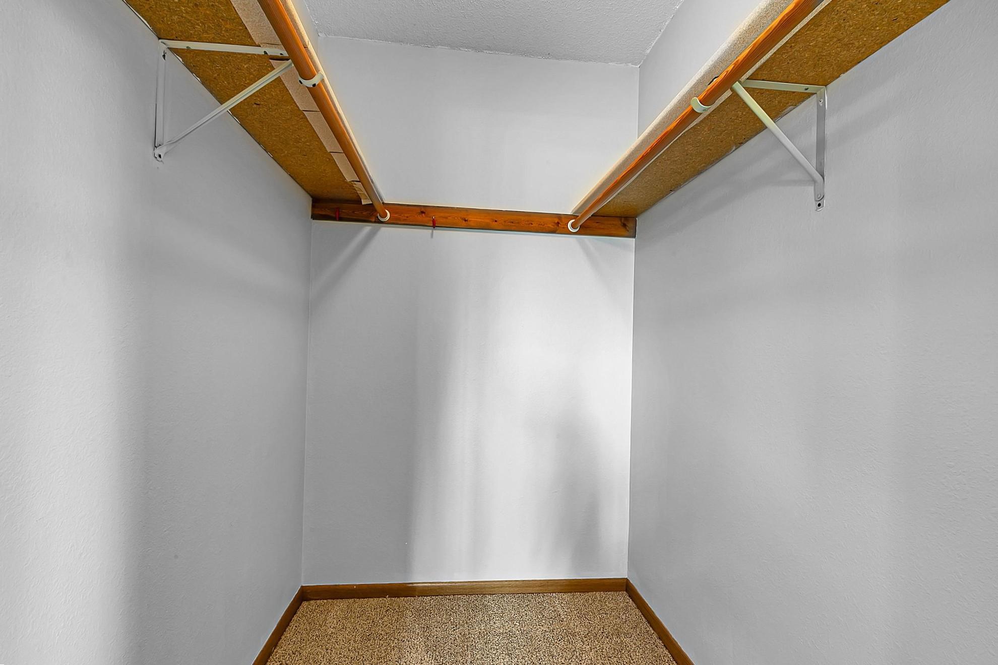 Walk in closet in primary bedroom