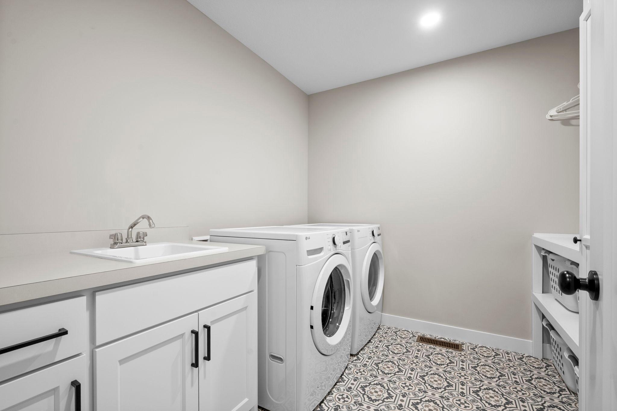 Upper level laundry with fun art deco flooring.