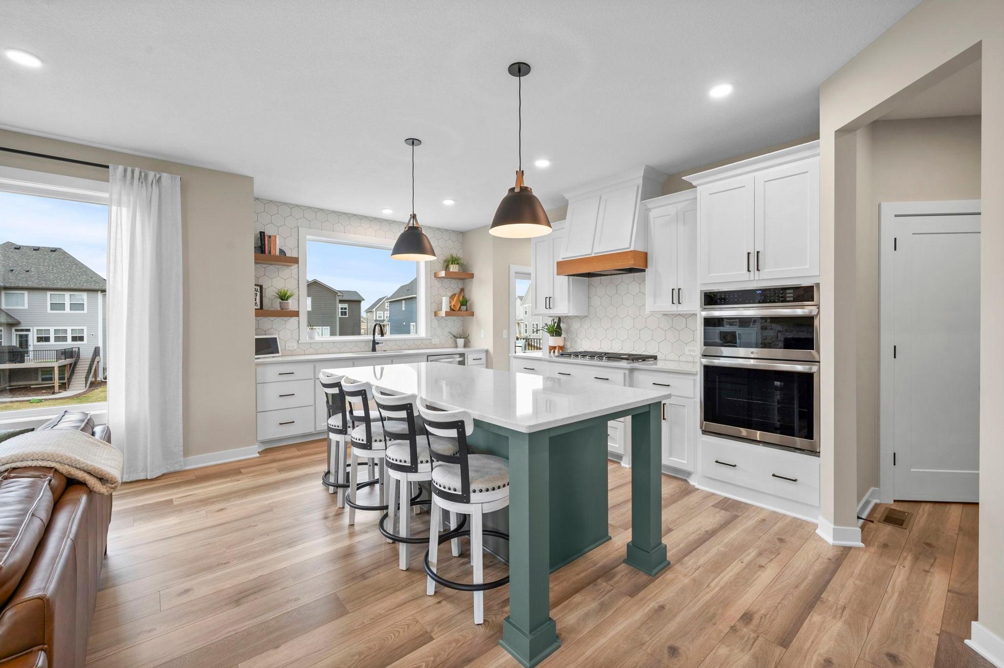 Matching stainless appliances including double wall oven.