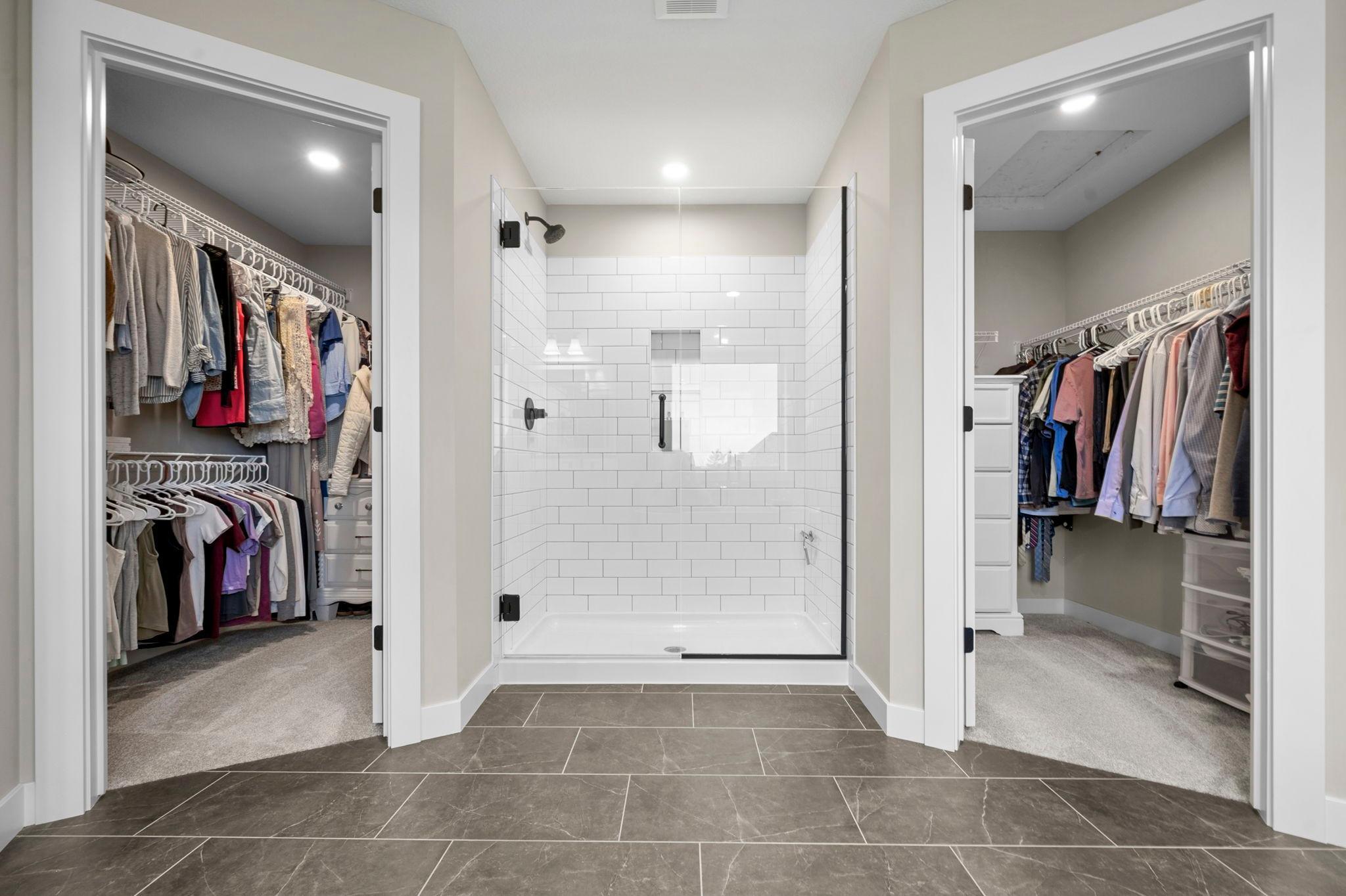 His and hers closets with spacious walk-in shower.