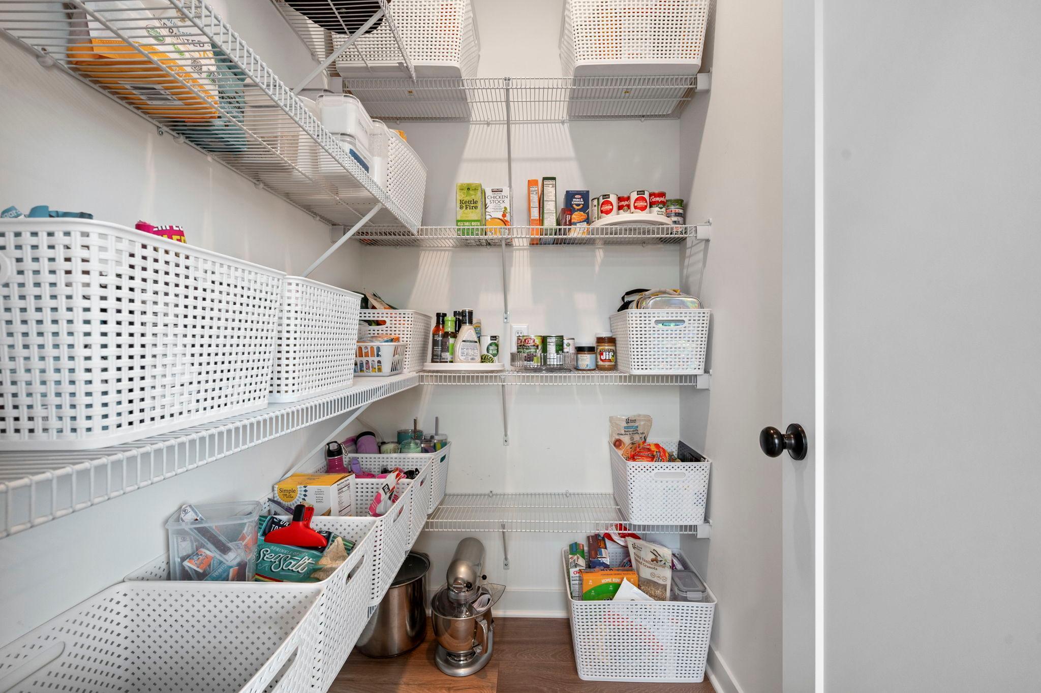 Spacious pantry for kitchen storage.